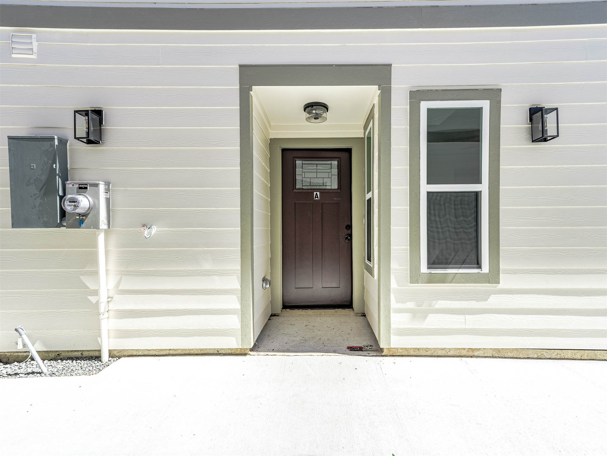 2018 Hampton Street, Unit A Houston, TX 77088 - Photo 28 of 30 This photo features a modern front door with a sleek design, incorporating a glass panel. It's set within a clean, neutral-toned entryway that highlights the contemporary style for the home.