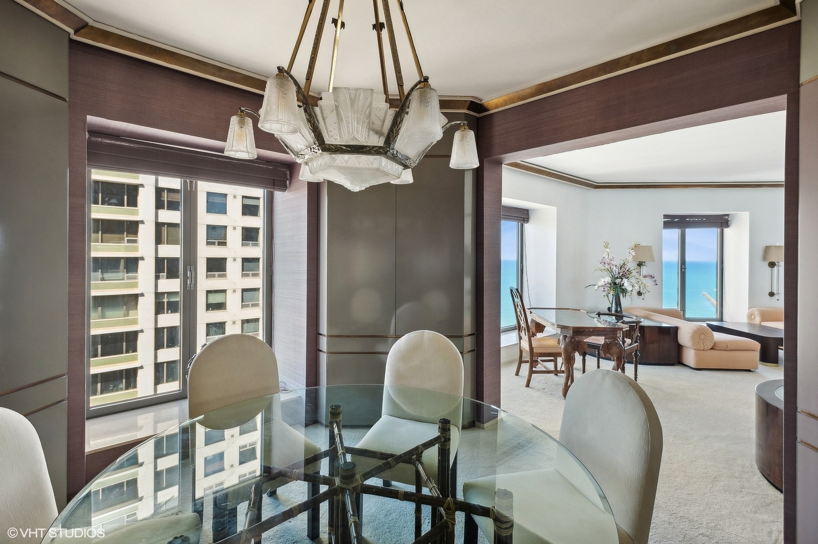950 North Michigan Avenue, Unit 2203 Chicago, IL 60611 - Photo 16 of 26 a dining room with furniture a chandelier and wooden floor