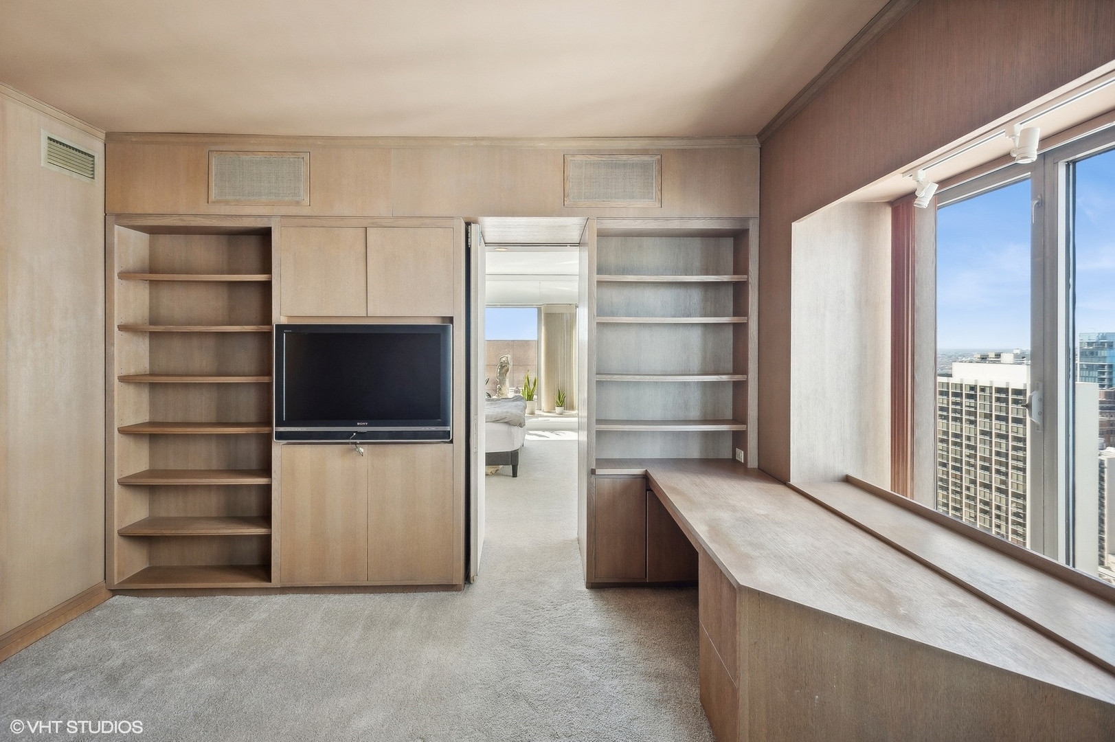 950 North Michigan Avenue, Unit 2203 Chicago, IL 60611 - Photo 20 of 26 a living room with a flat screen tv and a refrigerator