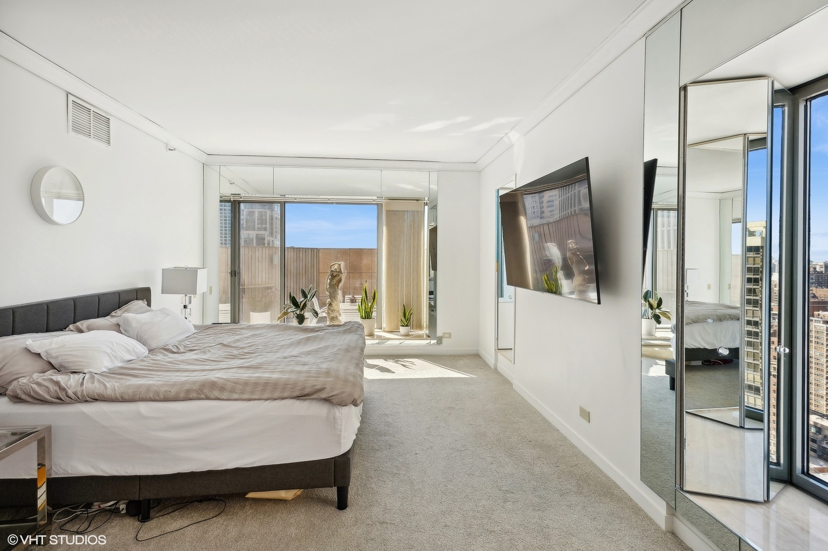 950 North Michigan Avenue, Unit 2203 Chicago, IL 60611 - Photo 21 of 26 a bedroom with a bed and glass walk in closet