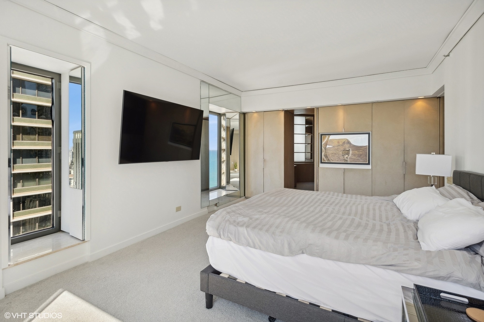 950 North Michigan Avenue, Unit 2203 Chicago, IL 60611 - Photo 22 of 26 a bedroom with a bed and a flat screen tv