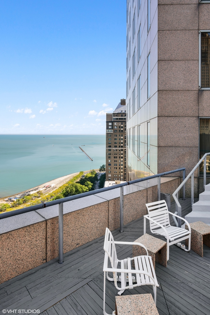 950 North Michigan Avenue, Unit 2203 Chicago, IL 60611 - Photo 3 of 26 a view of a balcony with chairs and wooden floor