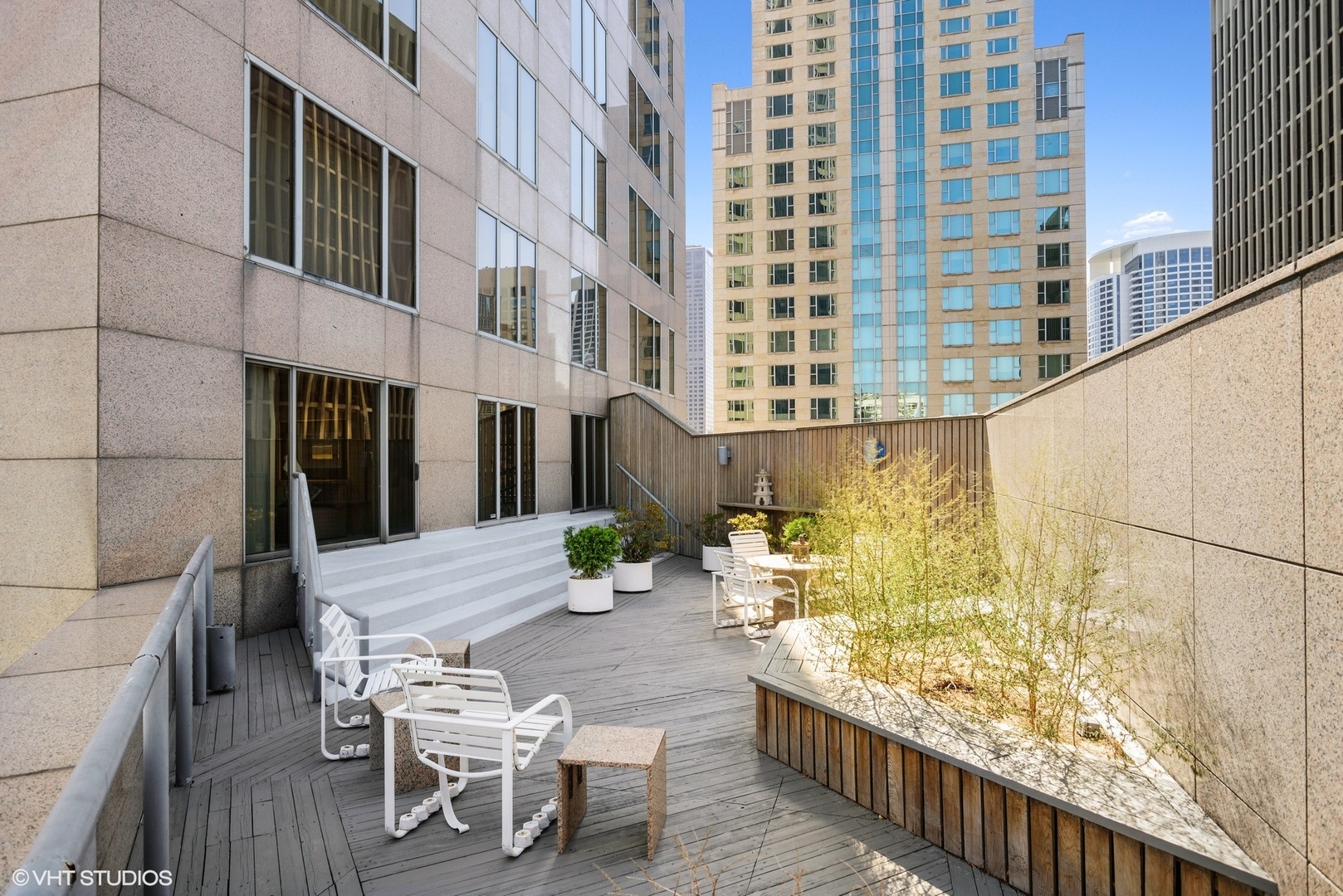 950 North Michigan Avenue, Unit 2203 Chicago, IL 60611 - Photo 4 of 26 a view of a balcony with chairs and wooden floor