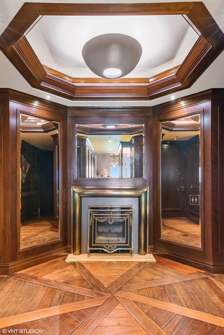 950 North Michigan Avenue, Unit 2203 Chicago, IL 60611 - Photo 7 of 26 a view of an empty room with a fireplace and a window