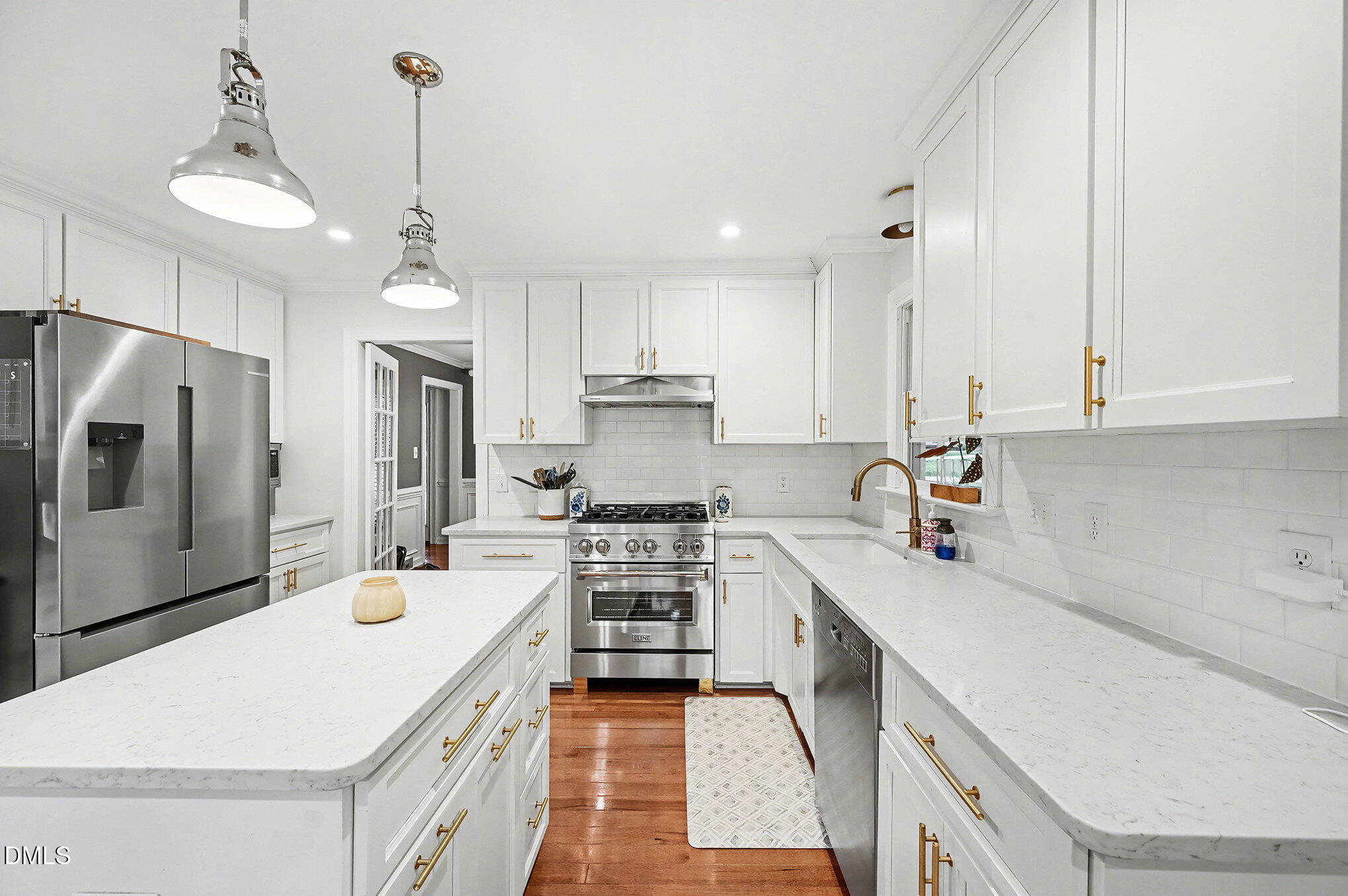 6332 Bayswater Trail Raleigh, NC 27612 - Photo 6 of 44 Renovated kitchen with Quartz countertops 2025 SS Refrigerator and dual fuel stove, dishwasher and microwave.