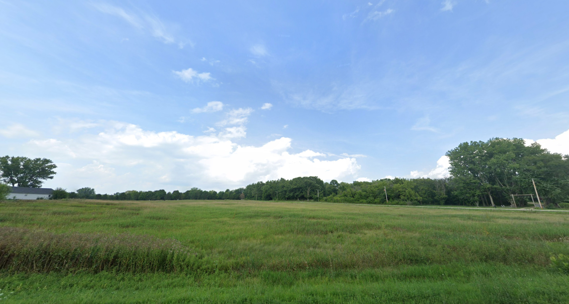 19209 River Road Marengo, IL 60152 - Photo 3 of 9 a view of a green field with trees in the background