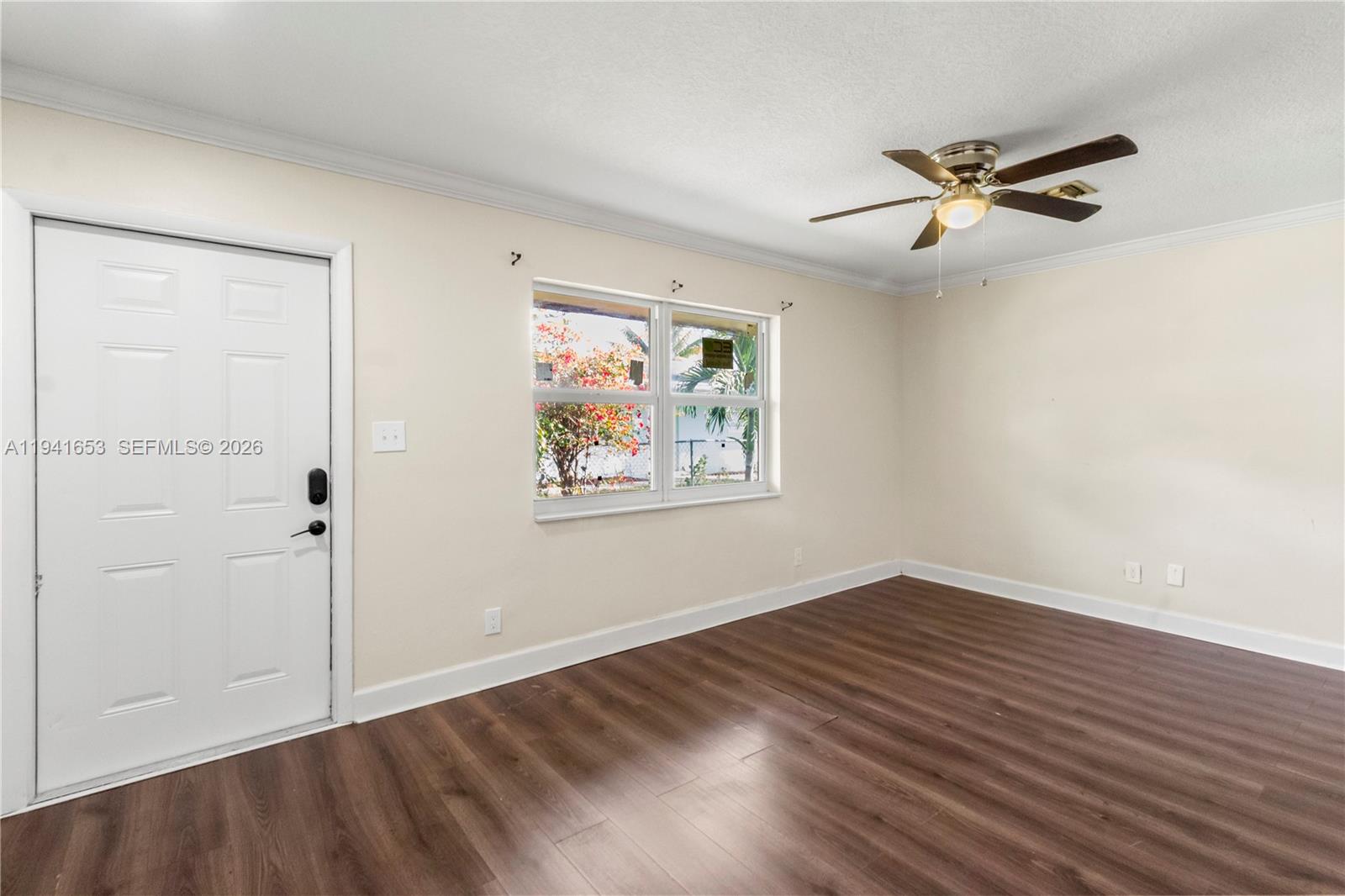 441 Northeast 30th Street, Unit 12 Pompano Beach, FL 33064 - Photo 14 of 33 an empty room with wooden floor closet and windows