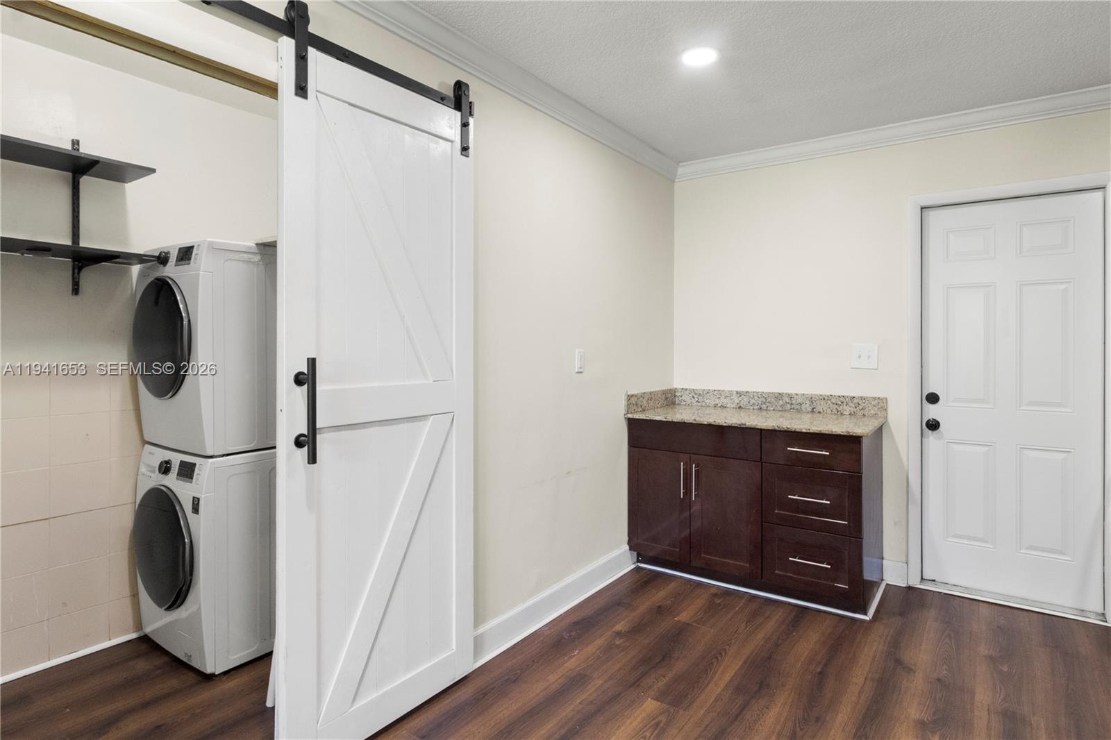 441 Northeast 30th Street, Unit 12 Pompano Beach, FL 33064 - Photo 17 of 33 a view of an empty room with wooden floor and a window
