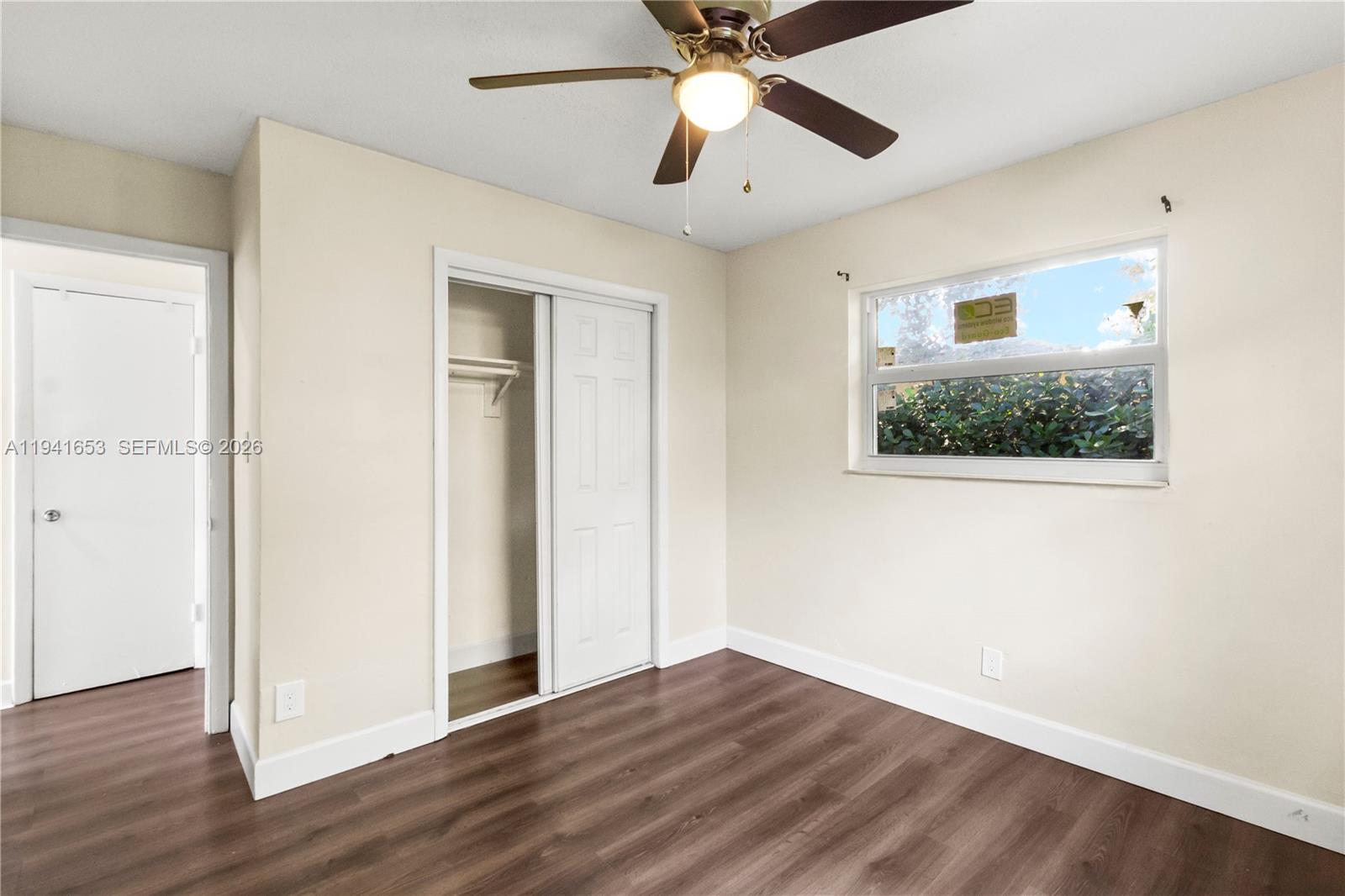 441 Northeast 30th Street, Unit 12 Pompano Beach, FL 33064 - Photo 26 of 33 a view of an empty room with wooden floor