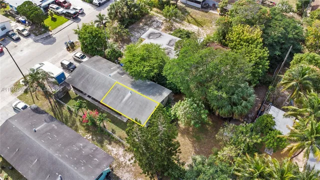 an aerial view of a house with a yard and garden