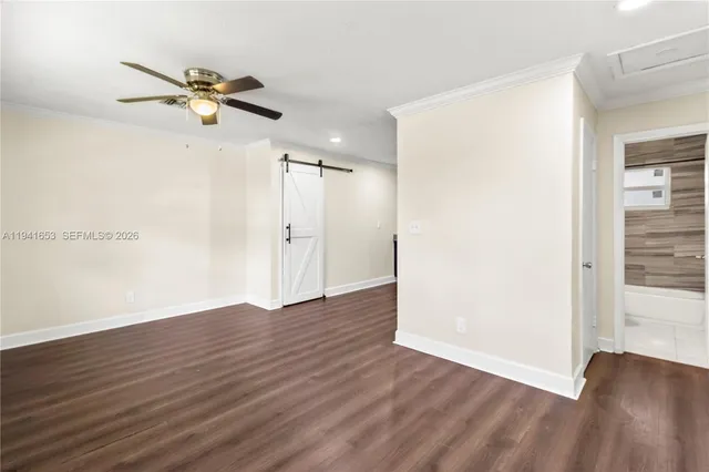 a view of empty room with wooden floor