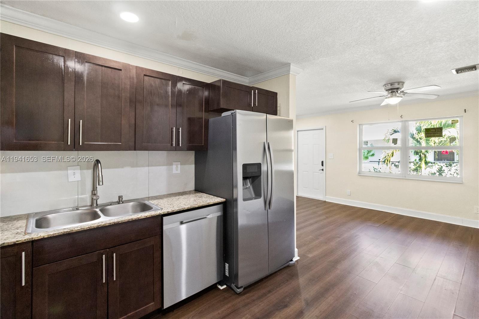 441 Northeast 30th Street, Unit 12 Pompano Beach, FL 33064 - Photo 5 of 33 a kitchen with stainless steel appliances granite countertop a refrigerator and a sink