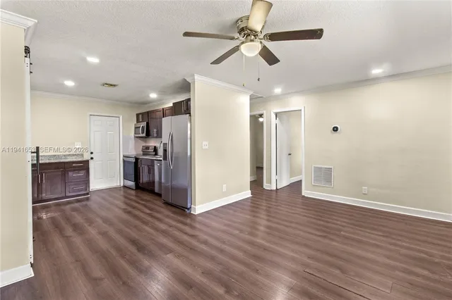 a view of kitchen with refrigerator microwave and wooden floor