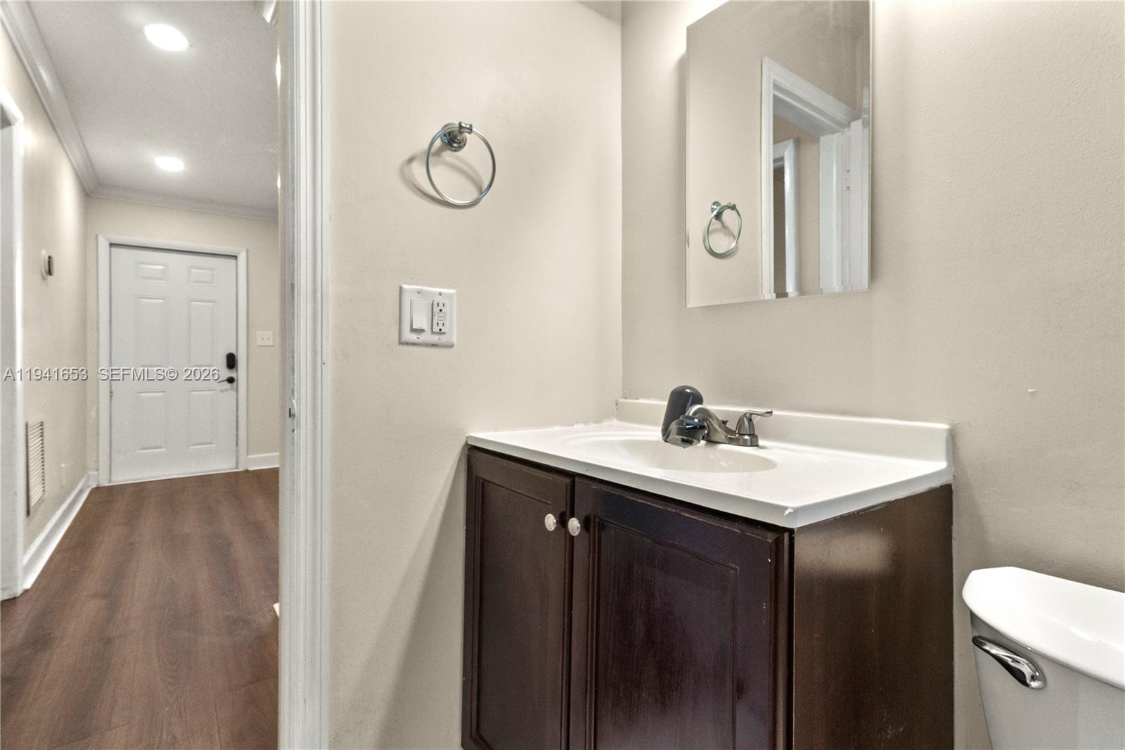 441 Northeast 30th Street, Unit 12 Pompano Beach, FL 33064 - Photo 7 of 33 a bathroom with a sink and a mirror