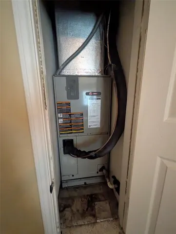 a view of a hallway with wooden floor and stairs