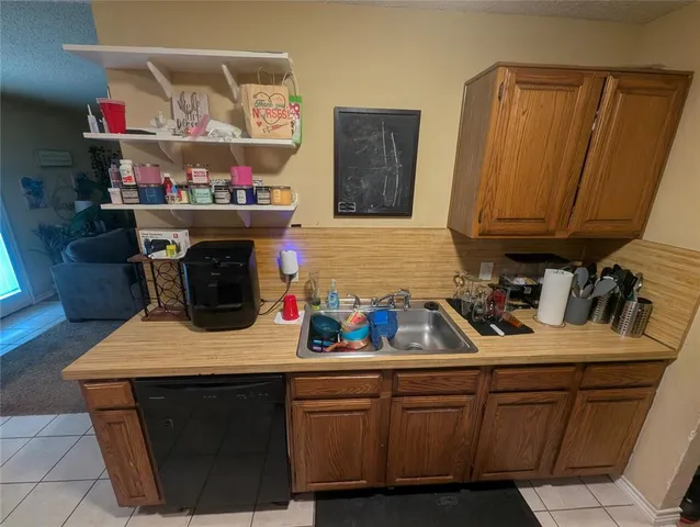 a kitchen with stainless steel appliances granite countertop a sink dishwasher stove and cabinets