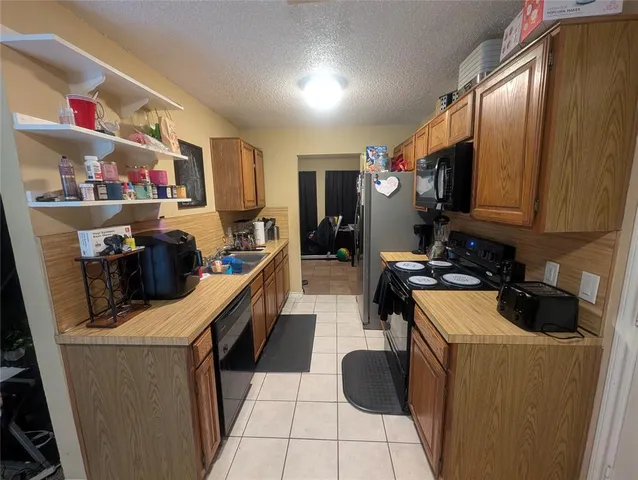 a kitchen with a sink appliances and cabinets