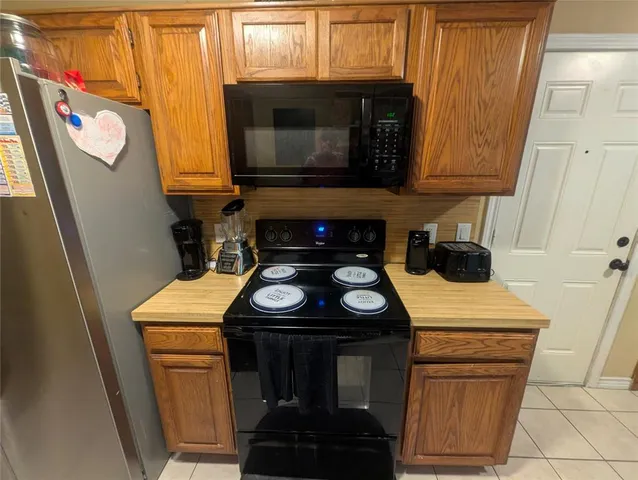 a kitchen with a sink stove and microwave