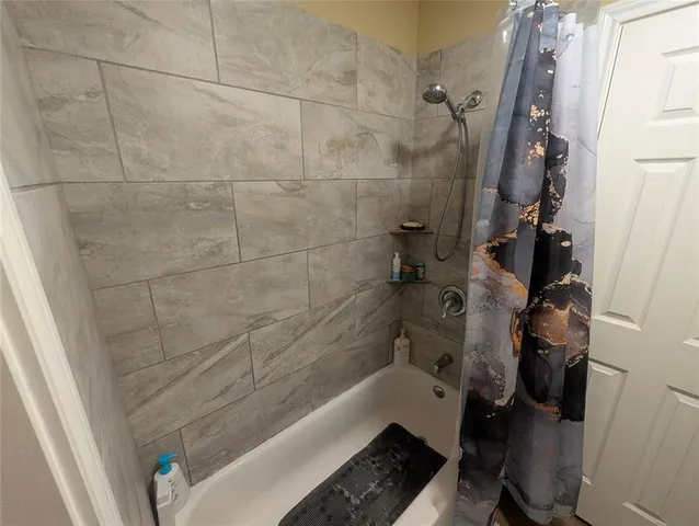 a bathroom with a bathtub and a shower