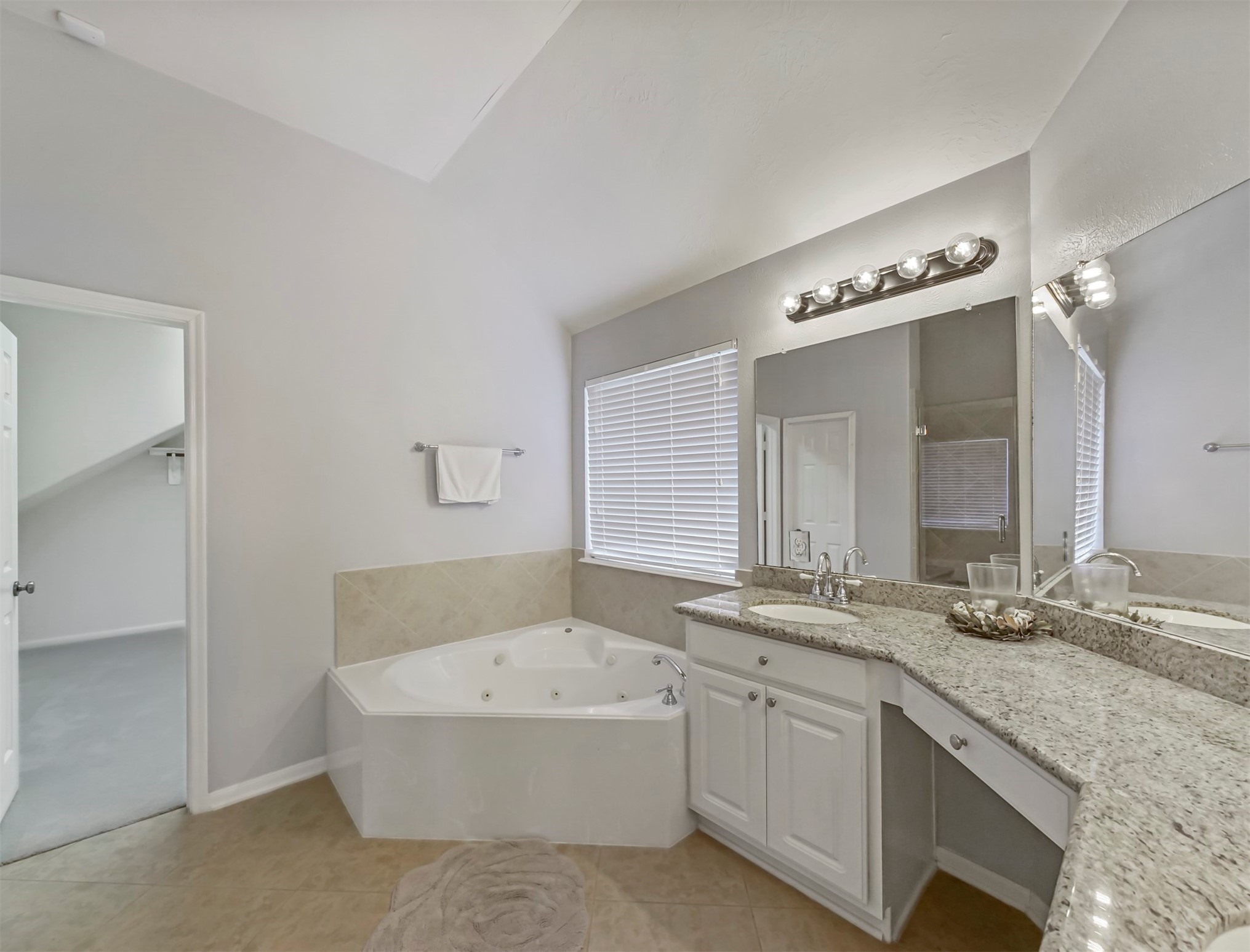 8214 Garrison Point Drive Houston, TX 77040 - Photo 18 of 37 a bathroom with a granite countertop sink mirror and a bathtub