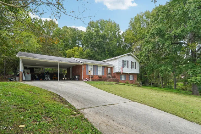 a front view of a house with a garden and porch