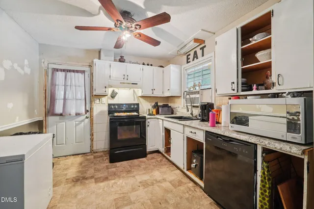 a kitchen with stainless steel appliances granite countertop a stove sink and cabinets