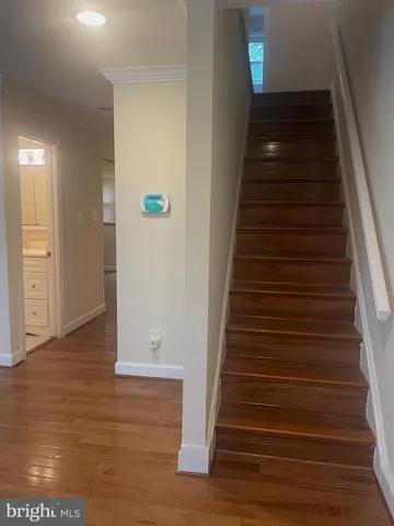 a view of entryway and hall with wooden floor