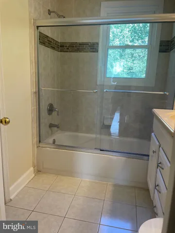 a bathroom with a bathtub and window