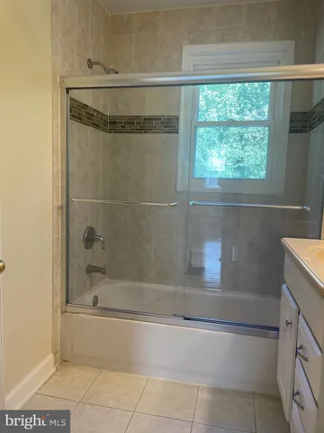 a bathroom with a shower and bathtub
