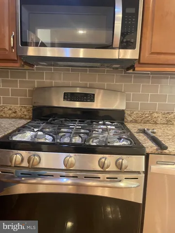 a stove top oven sitting inside of a kitchen