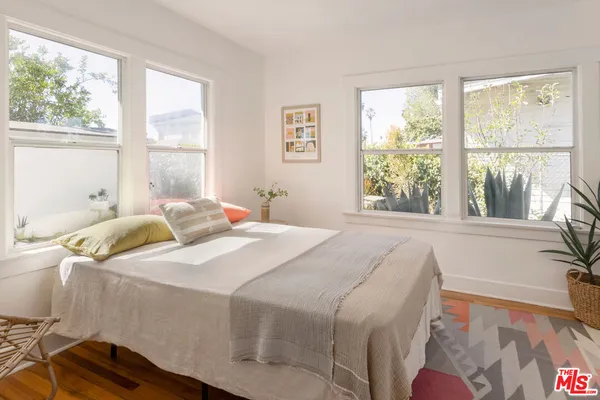 a bedroom with a bed and a large window