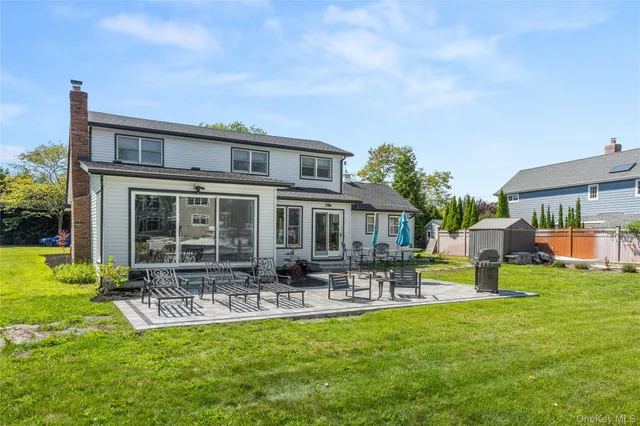 a front view of house with a garden and patio