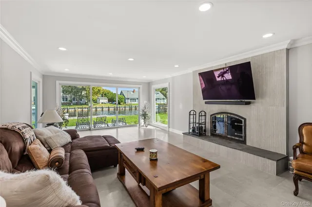 a living room with furniture a fireplace and a flat screen tv