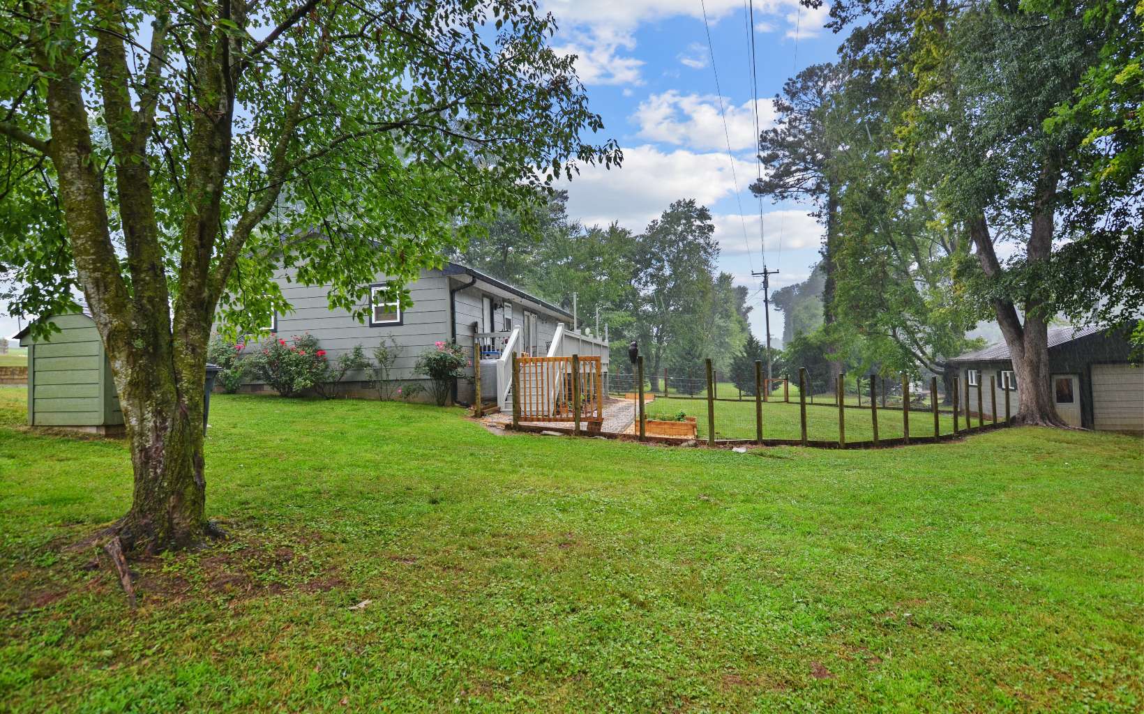 483 Parker Road Ellijay, GA 30536 - Photo 25 of 33 a view of a house next to a big yard and large trees