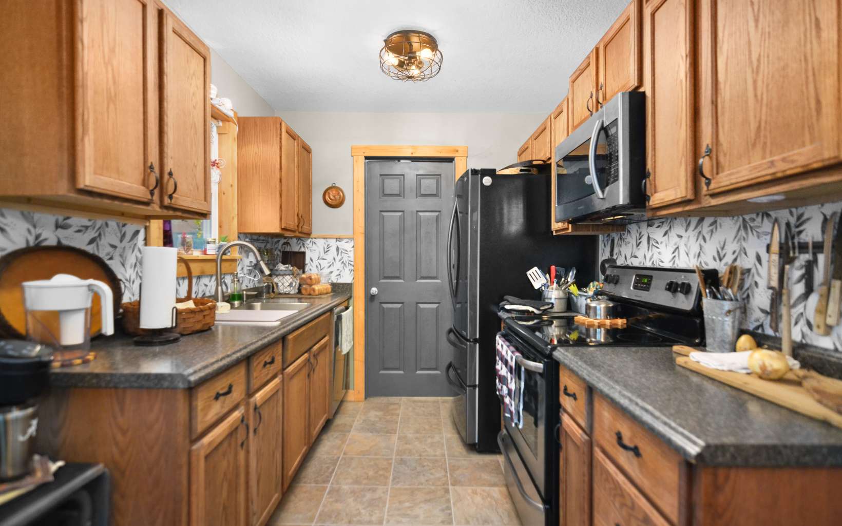483 Parker Road Ellijay, GA 30536 - Photo 6 of 33 a kitchen with stainless steel appliances granite countertop a sink stove and refrigerator