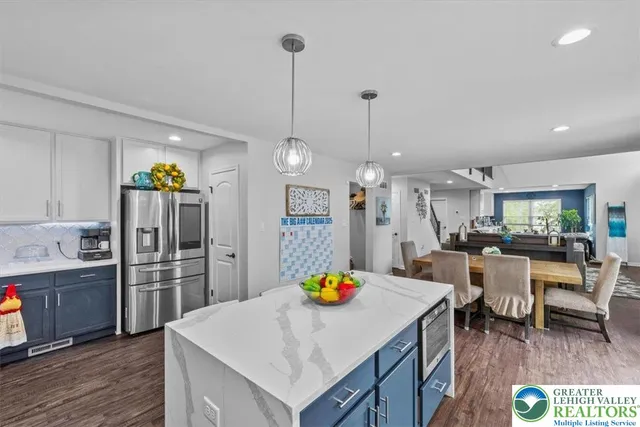 a kitchen with white cabinets and appliances