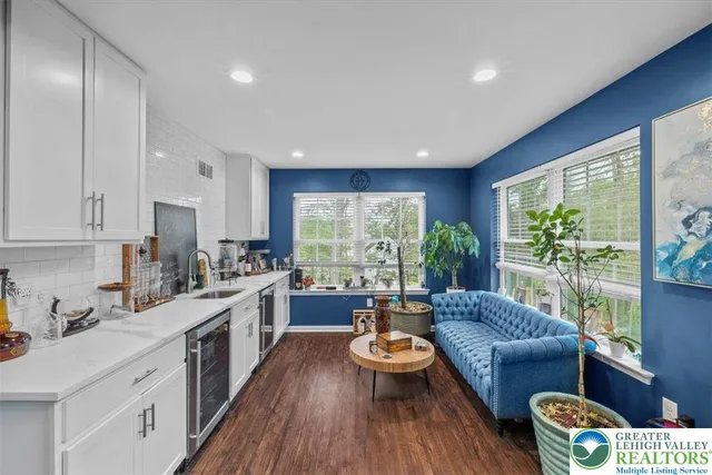 a view of entryway livingroom and hall with wooden floor