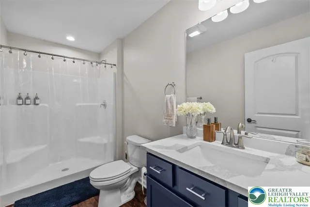 a spacious bedroom with a bed and a chandelier