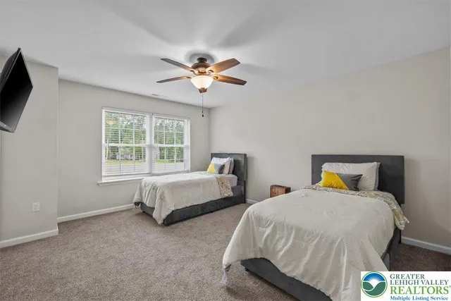 a bedroom with a large bed and a tv