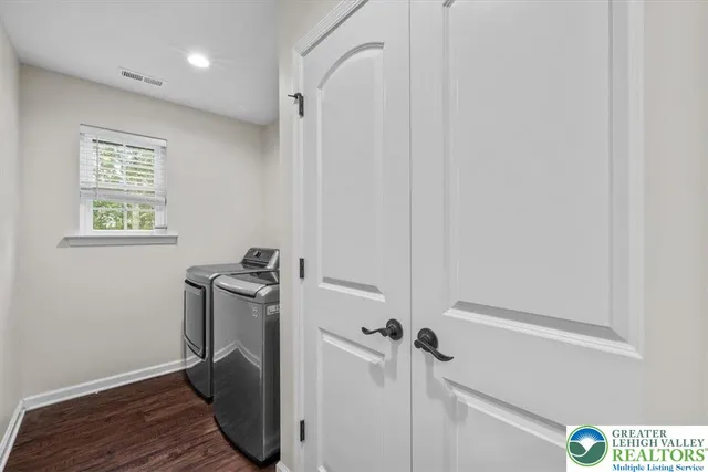 a living room with furniture and a gym machine