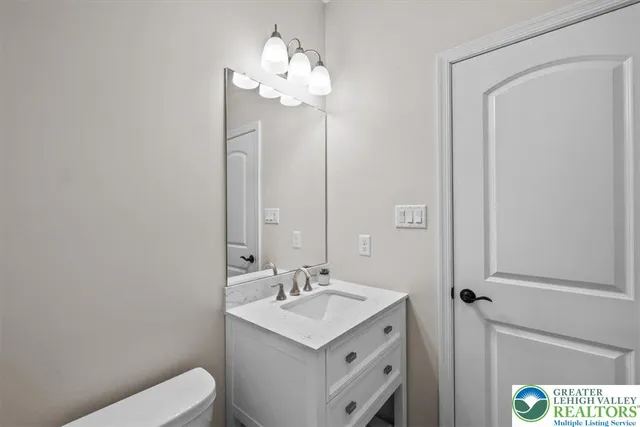 a living room with furniture a table and wooden floor