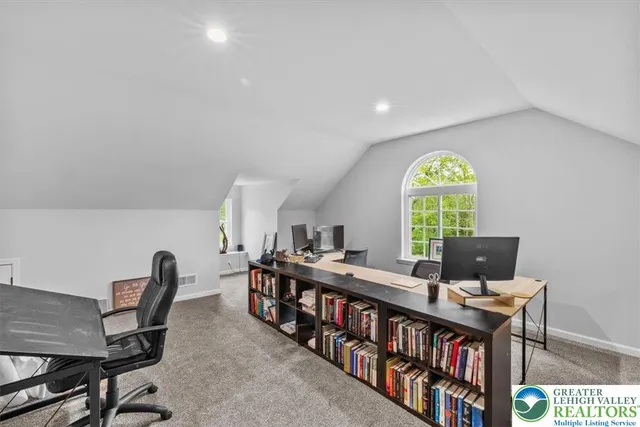 a living room with a table chairs and a wooden floor