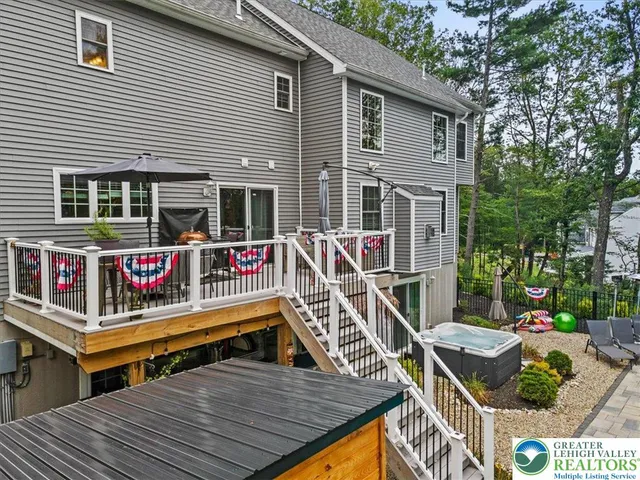 a view of a patio with table and chairs potted plants with wooden floor and fence