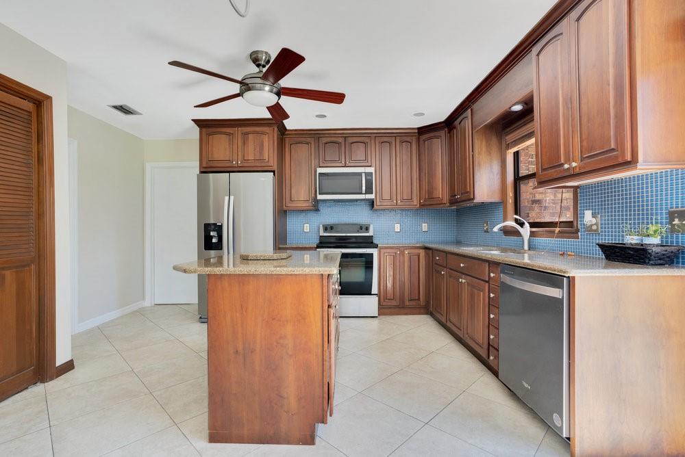 2088 Golden Arm Road Deltona, FL 32738 - Photo 15 of 51 a kitchen with stainless steel appliances granite countertop a refrigerator and a stove top oven