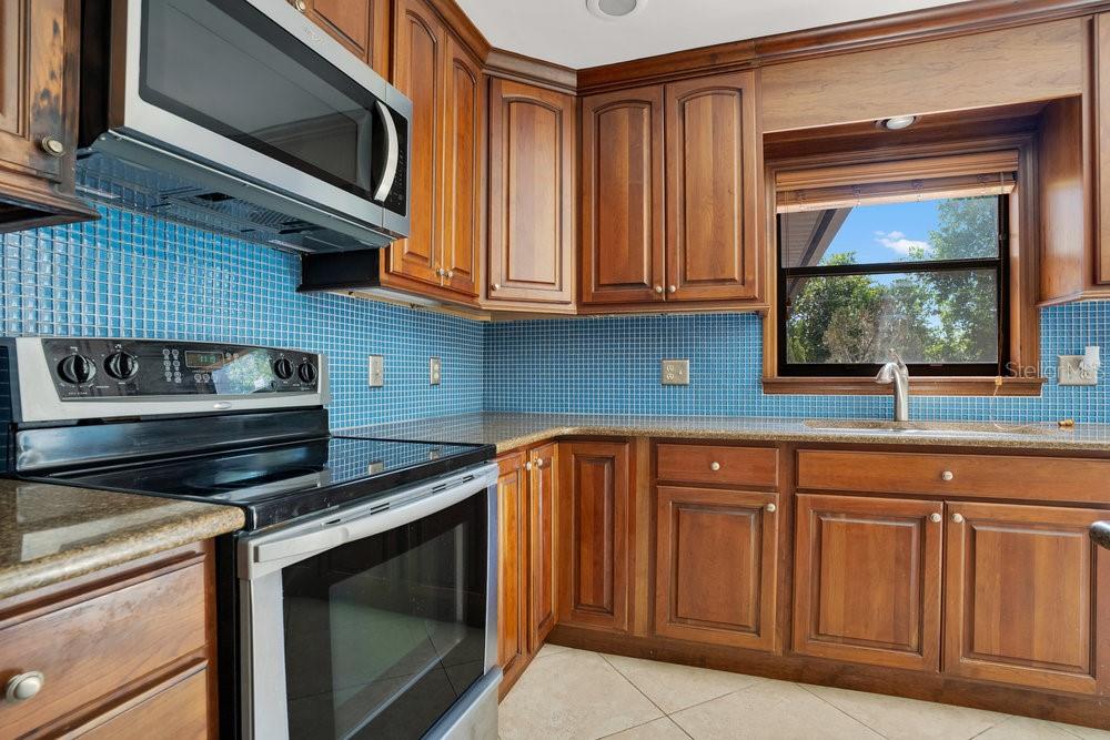 2088 Golden Arm Road Deltona, FL 32738 - Photo 18 of 51 a kitchen with granite countertop a stove microwave and sink
