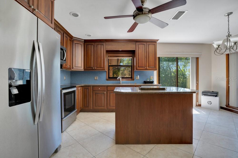 2088 Golden Arm Road Deltona, FL 32738 - Photo 20 of 51 a kitchen with stainless steel appliances granite countertop a refrigerator a sink dishwasher a stove and a refrigerator