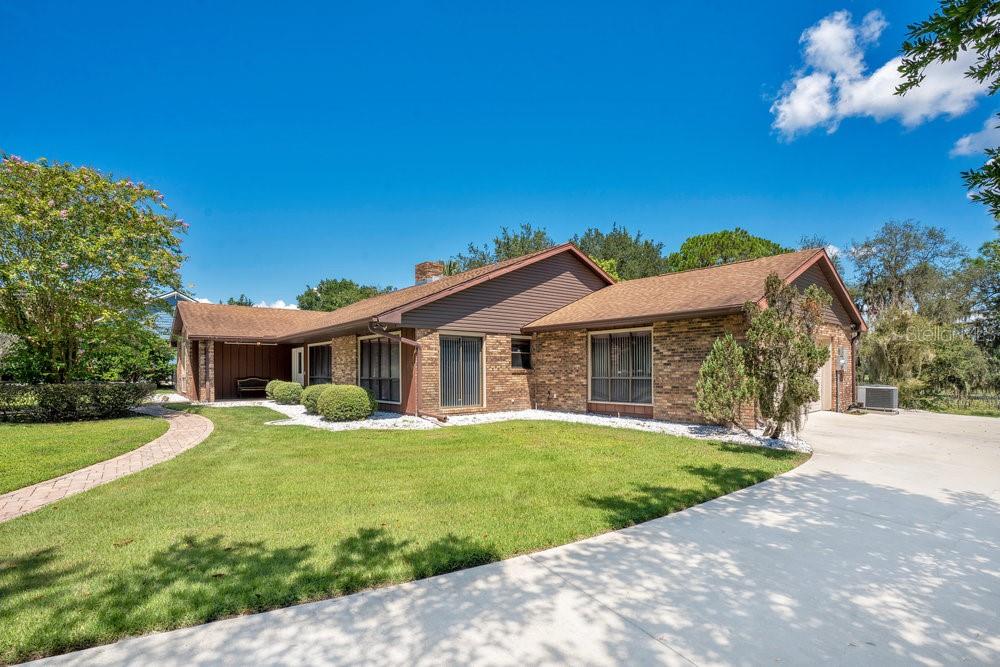 2088 Golden Arm Road Deltona, FL 32738 - Photo 2 of 51 a front view of house with yard and green space