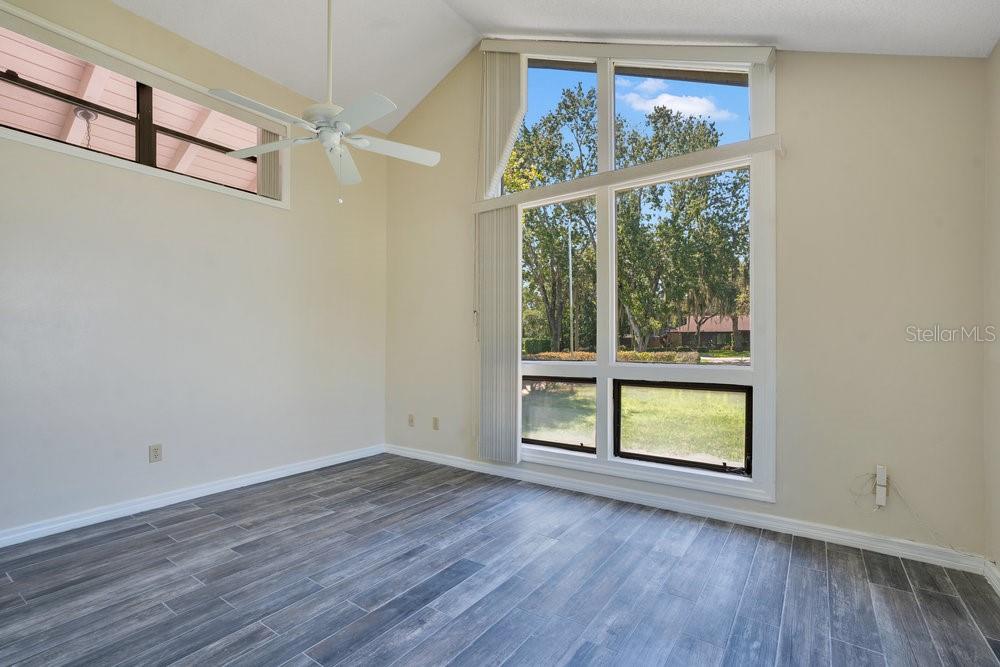 2088 Golden Arm Road Deltona, FL 32738 - Photo 22 of 51 an empty room with wooden floor and windows