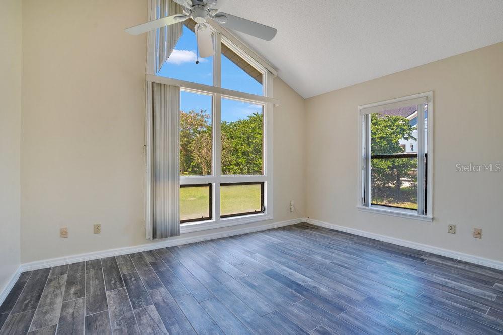 2088 Golden Arm Road Deltona, FL 32738 - Photo 23 of 51 an empty room with wooden floor fan and windows