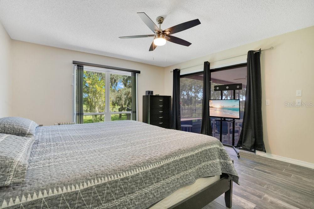 2088 Golden Arm Road Deltona, FL 32738 - Photo 24 of 51 a bedroom with a bed and a large mirror with a wooden floor